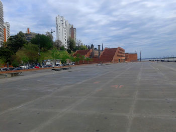 View of modern buildings against cloudy sky