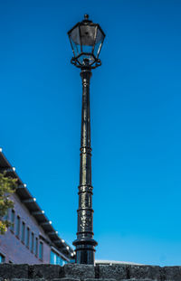 Low angle view of street light against building