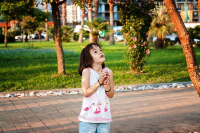 Little girl having fun outdoors in sunset