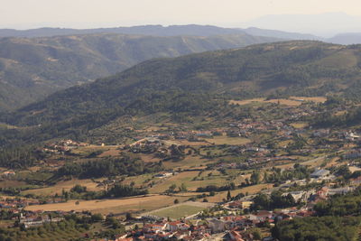 High angle view of townscape and mountains against sky