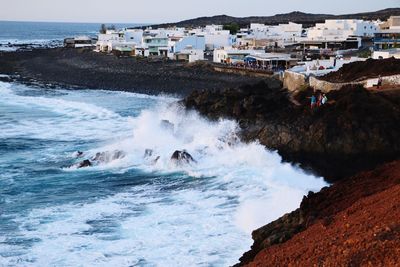 Scenic view of sea and houses against clear sky