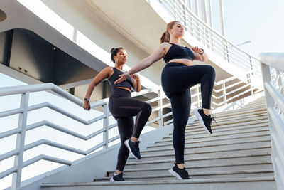 Low angle view of young woman exercising in gym