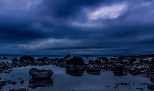 Scenic view of lake against cloudy sky