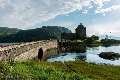 Scenic view of river against cloudy sky