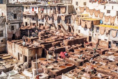 Workers dyeing textiles in clay containers