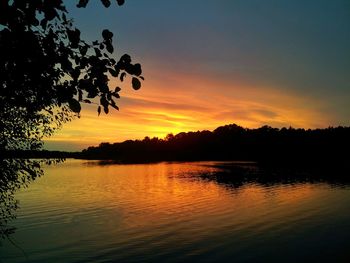 Scenic view of lake at sunset