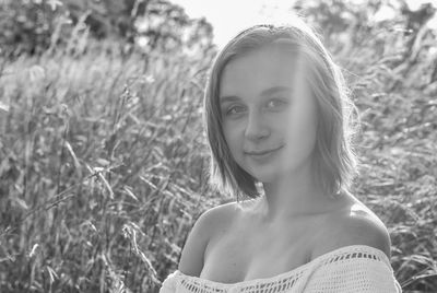 Portrait of a smiling young woman on field