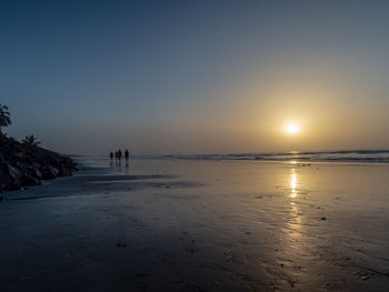 Scenic view of beach against sky during sunset