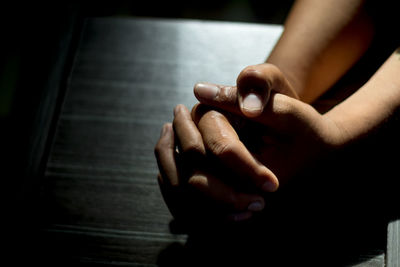 Asian man praying for god blessing in order to help oneself be free from suffering from stress 