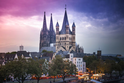 View of historic church in city at dusk