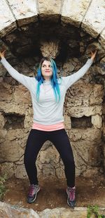 Full length portrait of woman standing outdoors