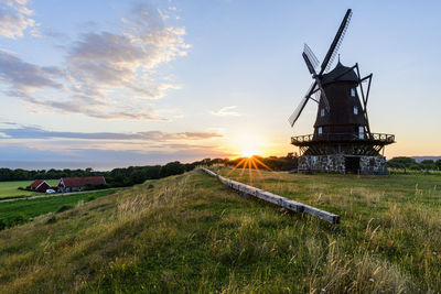 Wooden windmill at sunset