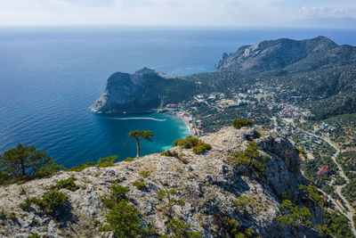 High angle view of rocks by sea against sky