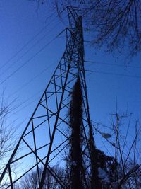 Low angle view of electricity pylon against sky