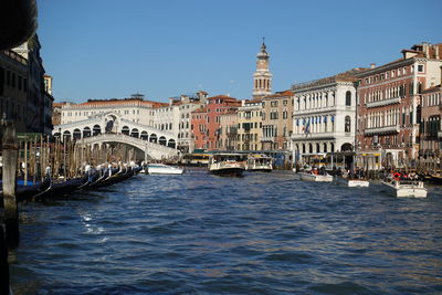 Boats in river in city