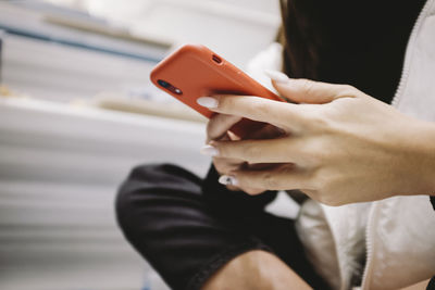 Midsection of man using mobile phone