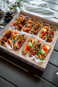 Eclairs with salmon, fresh vegetables and herbs, gourmet snacks.