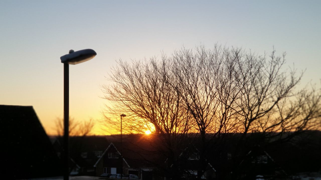 LOW ANGLE VIEW OF STREET LIGHT AGAINST SKY DURING SUNSET