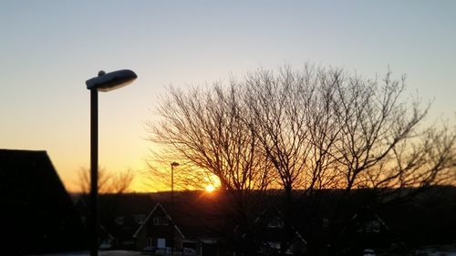 Low angle view of silhouette street light against sky during sunset