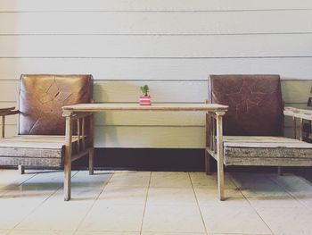 Chairs and table against wall