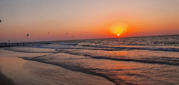 Scenic view of beach against sky during sunset