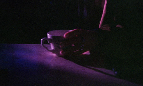 Cropped image of man holding illuminated lighting equipment