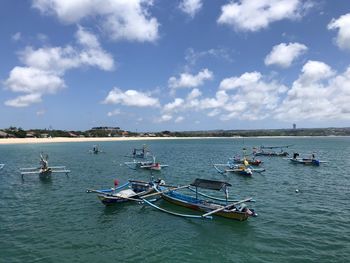 Boats in sea against sky