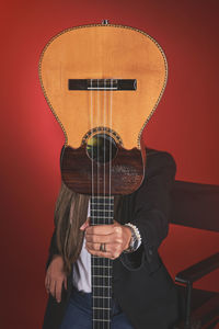 Beautiful young woman playing a cuatro, typical venezuelan instrument. recording session