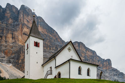 Low angle view of house on mountain against sky