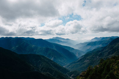 Scenic view of mountains against cloudy sky