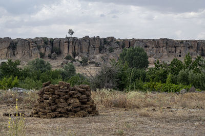 Rock formations on landscape against sky