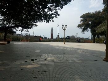 View of city street against cloudy sky