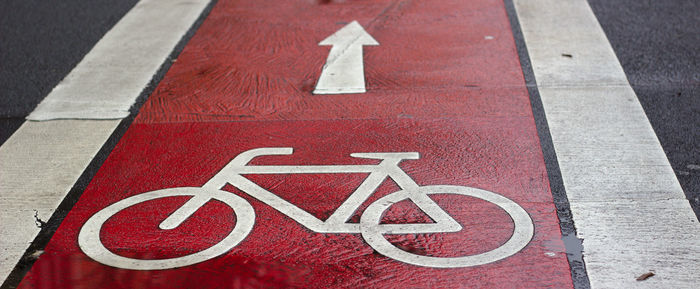 High angle view of arrow sign on road in city