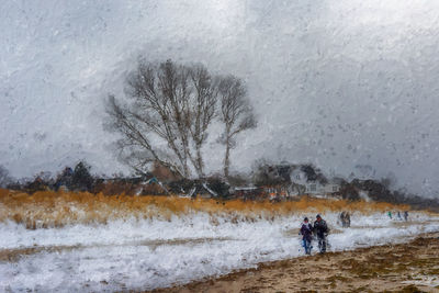 People on snow covered land during winter