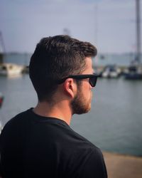 Portrait of young man against sea