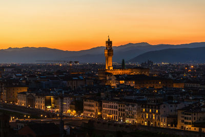 High angle view of illuminated buildings against sky during sunset