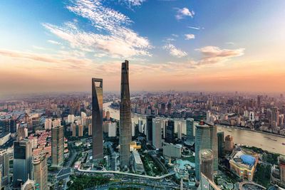 High angle view of modern buildings against sky during sunset