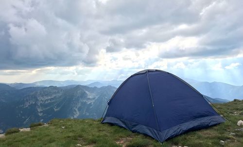 Tent on mountain against sky