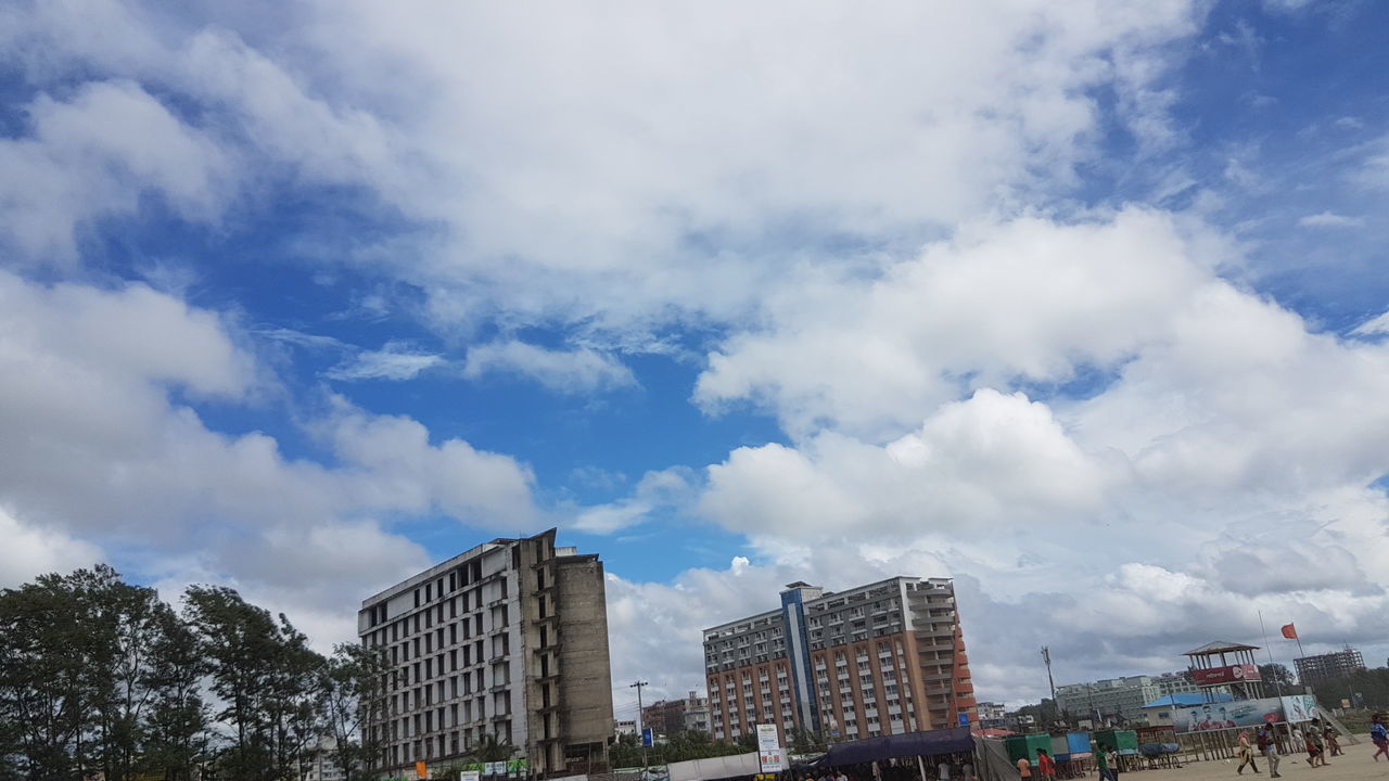 architecture, sky, cloud, built structure, city, building exterior, nature, building, cityscape, group of people, travel destinations, crowd, travel, day, tree, city life, skyline, urban area, street, outdoors, large group of people, skyscraper, tourism, downtown, horizon