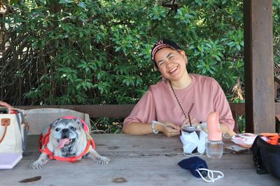 Portrait of young woman with dogs in park