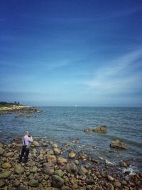 Rear view of man fishing in sea