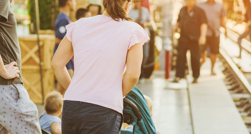 Rear view of people walking outdoors