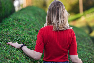 Rear view of woman with red leaf