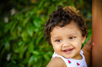 Portrait of cute baby girl smiling standing outdoors