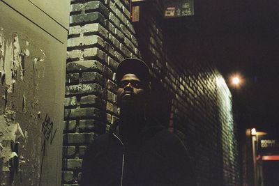 Portrait of young man looking at city buildings