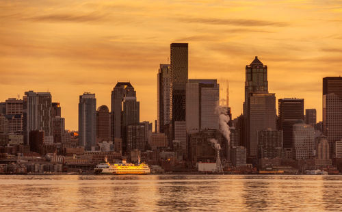 Seattle skyline and a washington state ferry. elliott bay is busy on a weekday morning.