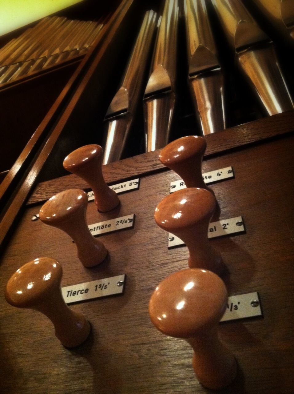 indoors, still life, close-up, table, communication, technology, music, metal, number, high angle view, arts culture and entertainment, no people, connection, musical instrument, text, wood - material, western script, equipment, old-fashioned, selective focus