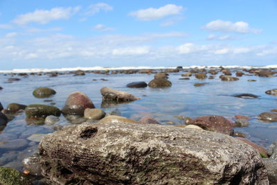Rocks on beach against sky