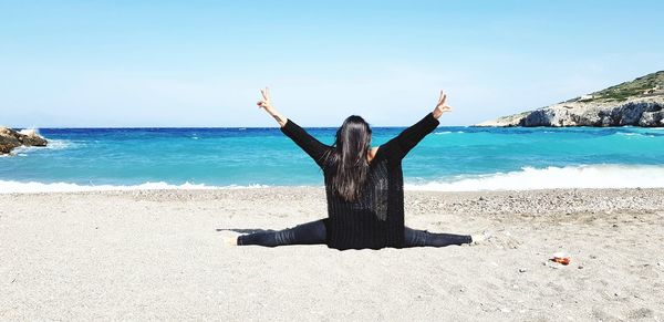 Man with arms raised on beach