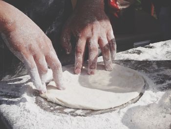 Cropped hands preparing food